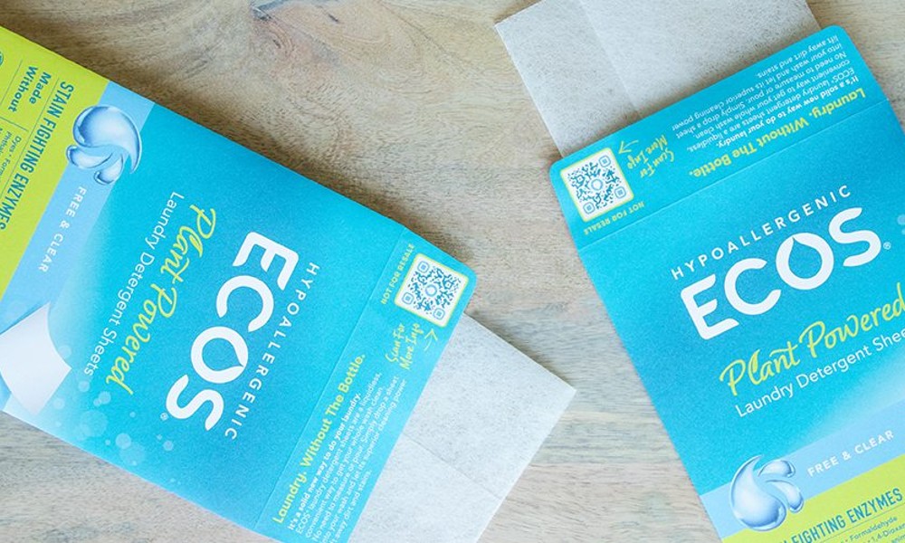 Eco-friendly pouches for ECOS laundry detergent sheets, featuring vibrant blue and green branding and a water-based latex closure, produced by JBM Packaging's wholesale packaging fufillment services.