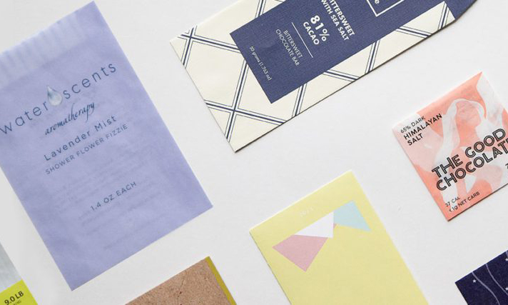 Brightly printed paper envelopes are arranged on a flat surface.