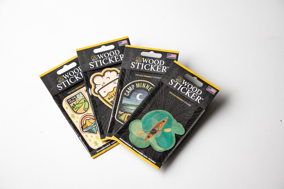 Retail display packaging for a wood sticker company, featuring a hanger hole and windowed packaging.